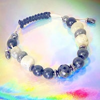 a black and white beaded bracelet on a colorful background